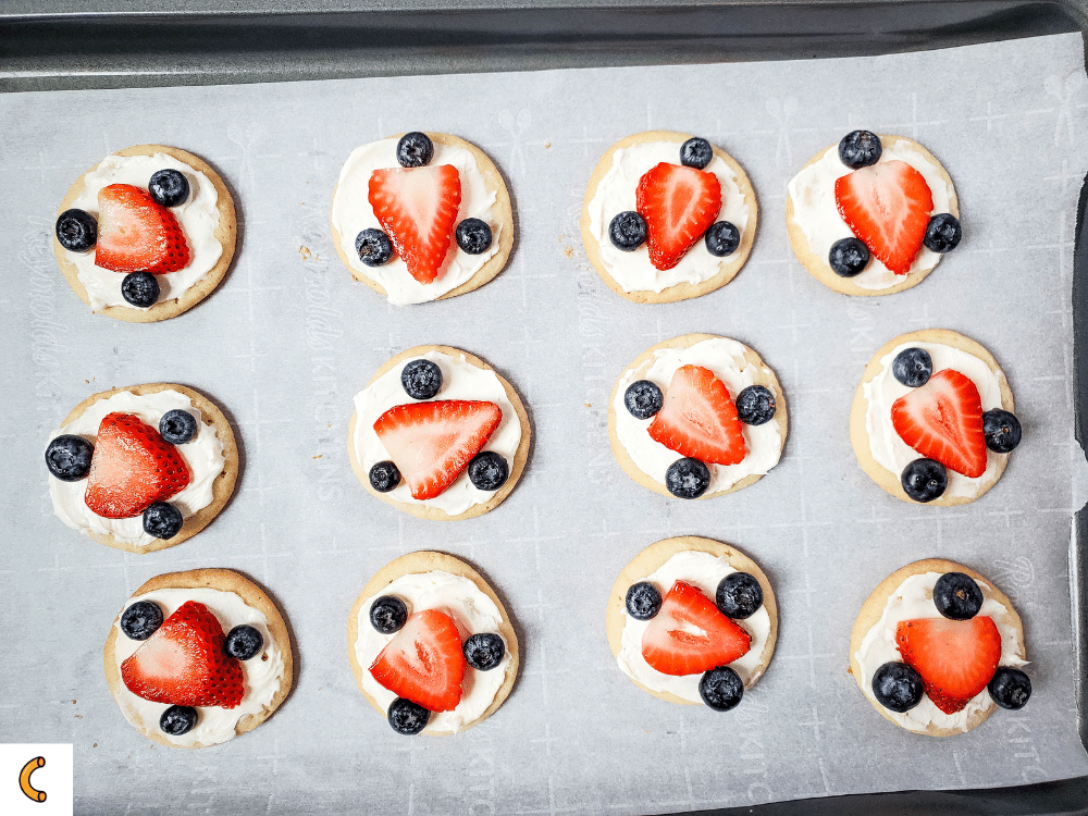 Top the cookies with an arrangement of blueberries and strawberries and enjoy!